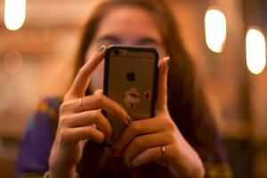 A young teen absorbed in her phone. 