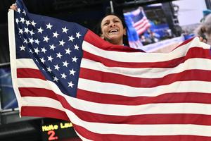 Elana Meyers Taylor waves a U.S. flag after winning gold in the bobsled women's monobob during the Milan Cortina 2026 Winter Olympic Games on Feb. 16, 2026.