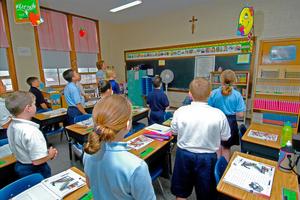 Students participate in daily classroom prayer at St. Mary Catholic Elementary School in St. Clair, Michigan, on May 11, 2024.