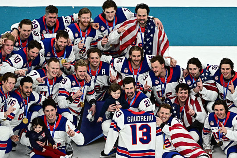 Gold-medalist USA players pose during the medal ceremony of the men’s ice hockey event at the Milano Santagiulia Ice Hockey Arena, during the Milano Cortina 2026 Winter Olympic Games in Milan, on Feb. 22. Joining the American team in the picture are two of the children of Johnny Gaudreau, a Catholic player who died in 2024.