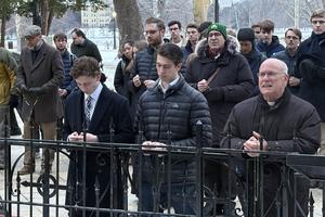 Bishop Kevin Rhoades (right) kneels with student organizers at the Grotto of Our Lady of Lourdes on the campus of the University of Notre Dame during a Rosary for the university's Catholic identity on Feb. 24, 2026. 