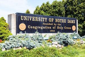 A sign stands at the entrance of the University of Notre Dame in South Bend, Indiana.