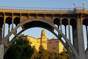 The Colorado Street Bridge spans the Arroyo Seco in Pasadena, California, its arch framing the Richard H. Chambers U.S. Court of Appeals building, home to the U.S. 9th Circuit Court of Appeals.