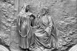 This bronze relief depicting Jesus talking with the Samaritan woman at the well is from the gate of Basilica Collegiata di San Sebastiano, probably from the 19th century.