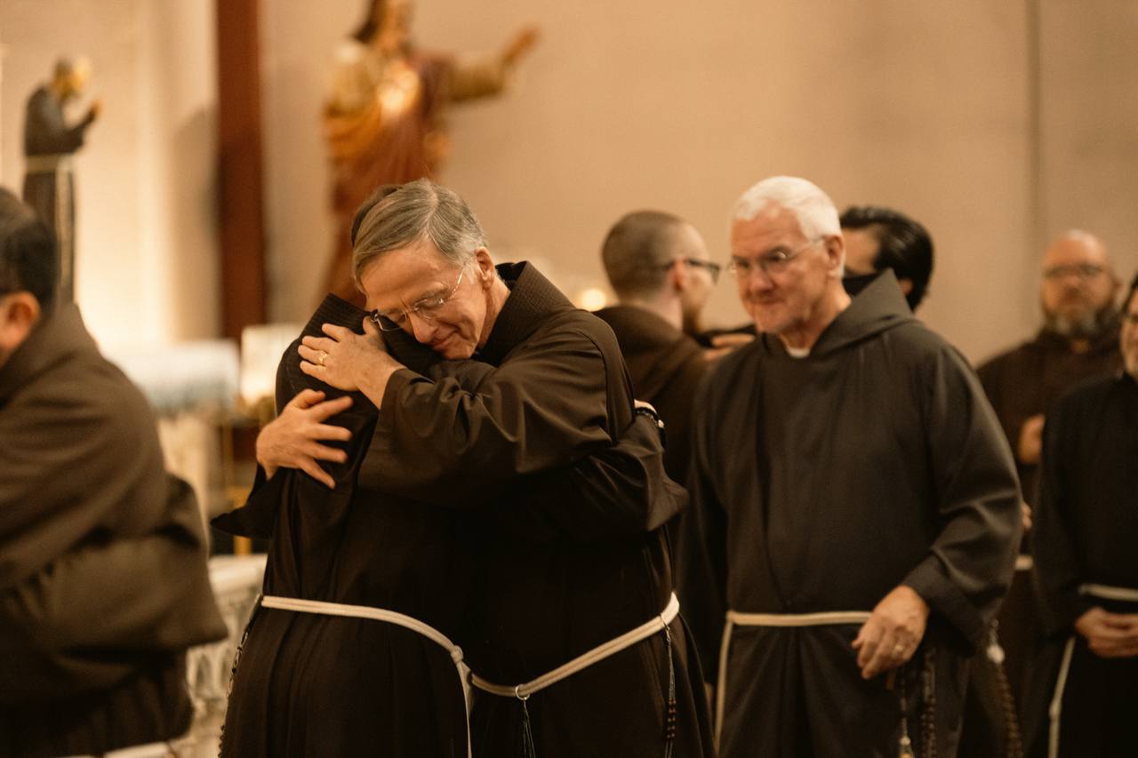 Capuchin friars hug after a prayer service at St. Francis Friary. 