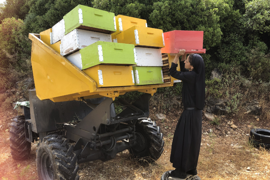 Sister Lea Lahoud loads up her bees on her ATV for transport.