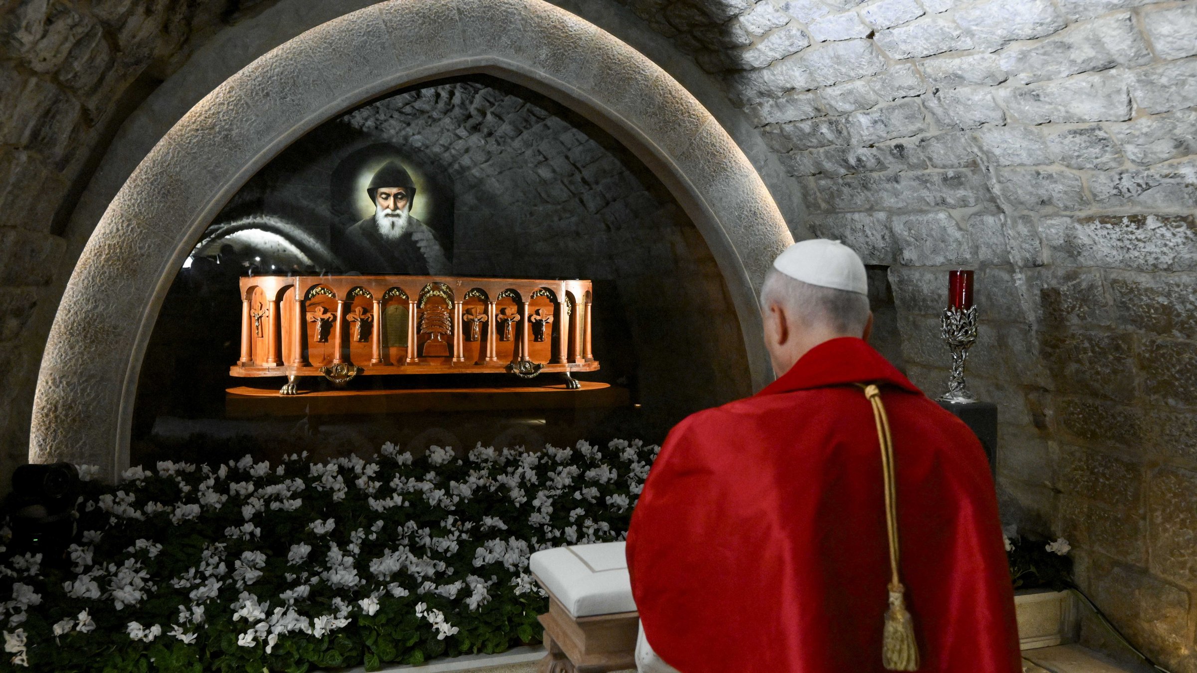 Pope Leo XIV prays in front of the tomb of St. Charbel.