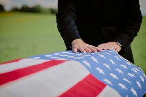 Military chaplain Deacon Conrad Donarski, known as CJ from his own military background, led the ceremony and prayed over the casket of Lonnie Wayman, a man he could personally call "friend" after meeting him in hospice care.