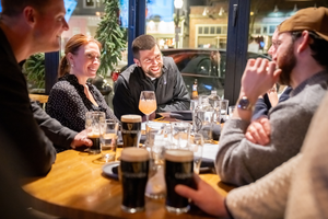 Father Peter Schirripa, center, talks with other participants of a Catholic young adults group in South Boston, at The Playwright, a bar near Gate of Heaven Church, where the Wednesday night sessions begin.