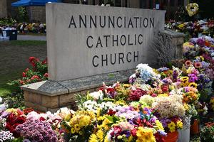 Flowers are placed outside Annunciation Catholic Church in Minneapolis on Sept. 3, 2025, after the Aug. 27 shooting in which a gunman killed two children and wounded 17 others during a school Mass. 