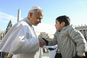 Pope Leo XIV greets a young pilgrim during his Wednesday general audience on Dec. 31, 2025, in St. Peter’s Square at the Vatican.