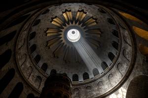 Light shines over the Edicule, traditionally believed to be the burial site of Jesus Christ, at the Church of the Holy Sepulchre in the Old City of Jerusalem, during the Orthodox Good Friday on May 3, 2024. 