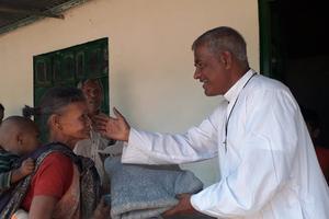 Monsignor Gabriel Corraya distributes warm clothes to needy in the Sylhet Diocese in Bangladesh on Nov. 18, 2022. 