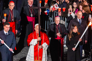 Pope Leo XIV carries the cross during the Via Crucis at the Colosseum in Rome, Friday, April 3, 2026. 