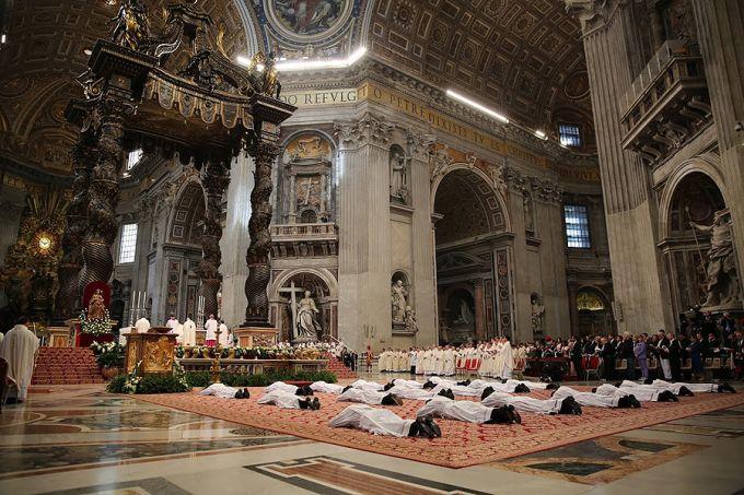 Nineteen men lie prostrate for their ordination as priests for the Diocese of Rome on April 26, 2015. | 