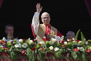 Pope Leo waves to the faithful from the loggia following his Easter message and blessing on April 5, 2026.
