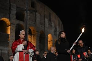 Pope Leo carries the cross in the Colosseum on Good Friday, April 3, 2026, during the Way of the Cross.