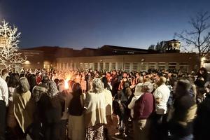 Parishioners gather around the fire at the start of the Easter Vigil on April 4 at Holy Trinity Parish in Westminster, Colorado.