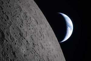 A crescent Earth rises beyond the moon’s cratered surface as NASA’s Artemis II crew passes behind the lunar limb on April 6.