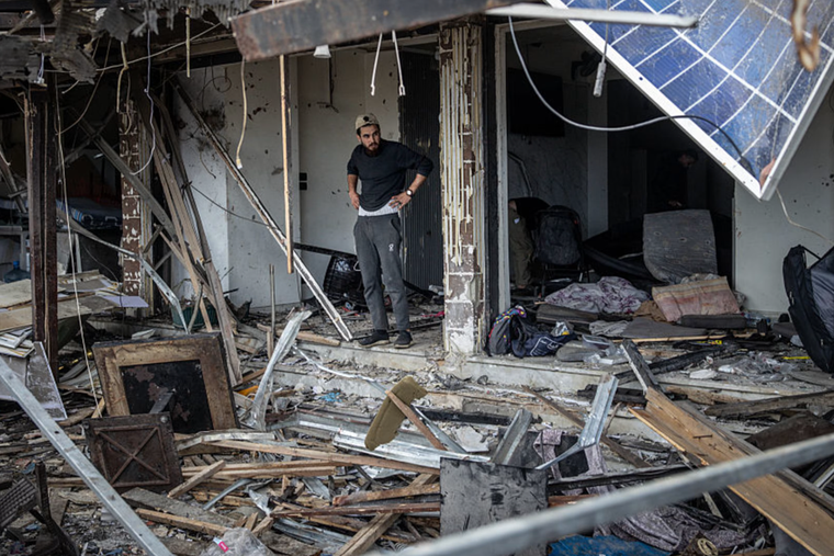 A man walks through a shop that was destroyed by an Israeli drone strike on April 8, 2026, in Sidon, Lebanon. 