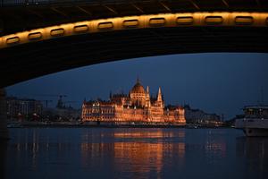 The Hungarian Parliament building, the iconic symbol of the Hungarian capital of Budapest, is seen with the Margaret Bridge illuminated on April 10, 2026, two days before the general election in Hungary. 