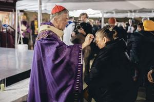 Cardinal Blase Cupich, archbishop of Chicago, distributes ashes outside at Our Lady of Mount Carmel Church at Ash Wednesday Mass, Feb. 18, 2026.