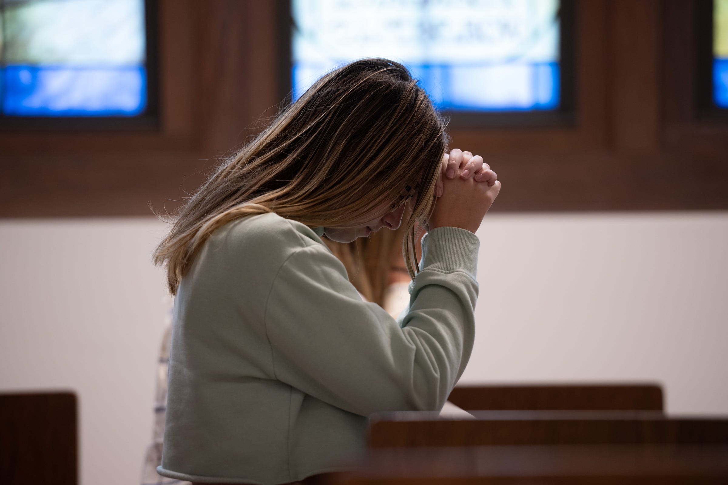 A young woman prays during Adoration inside the chapel on the campus of CUA. 