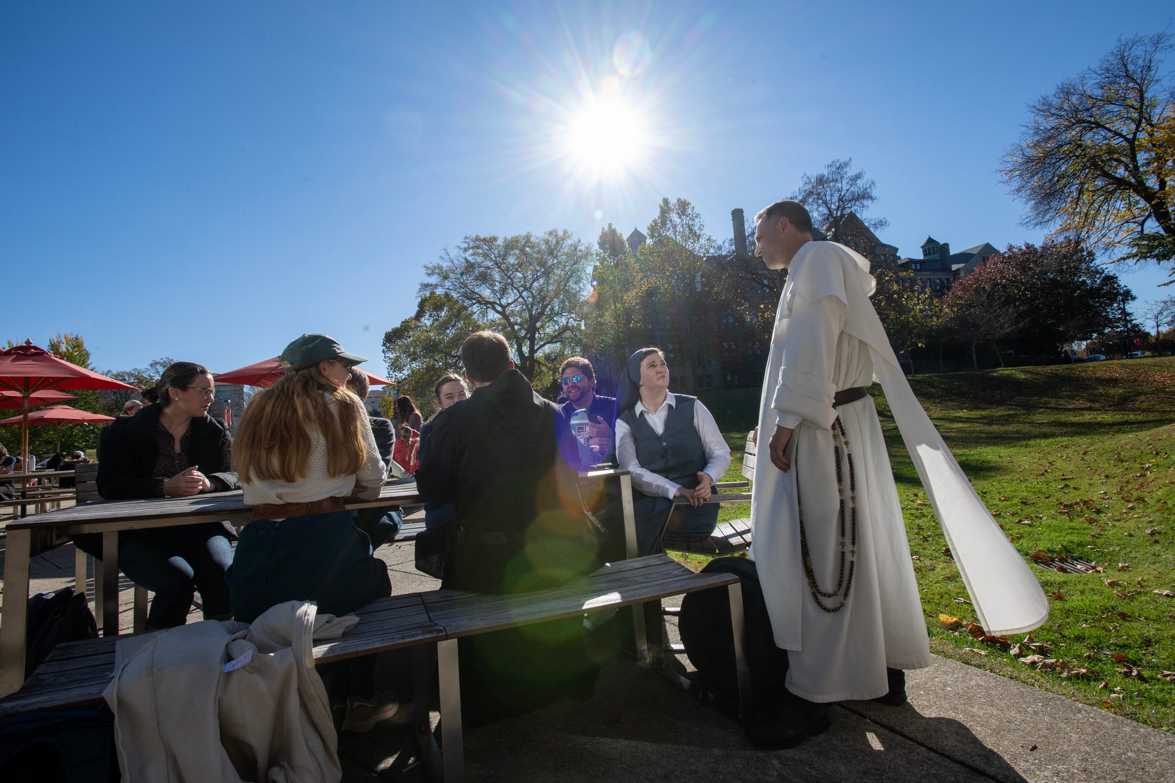 Chaplain and VP of CUA Father Aquinas Guilbeau speaks with students on campus. 