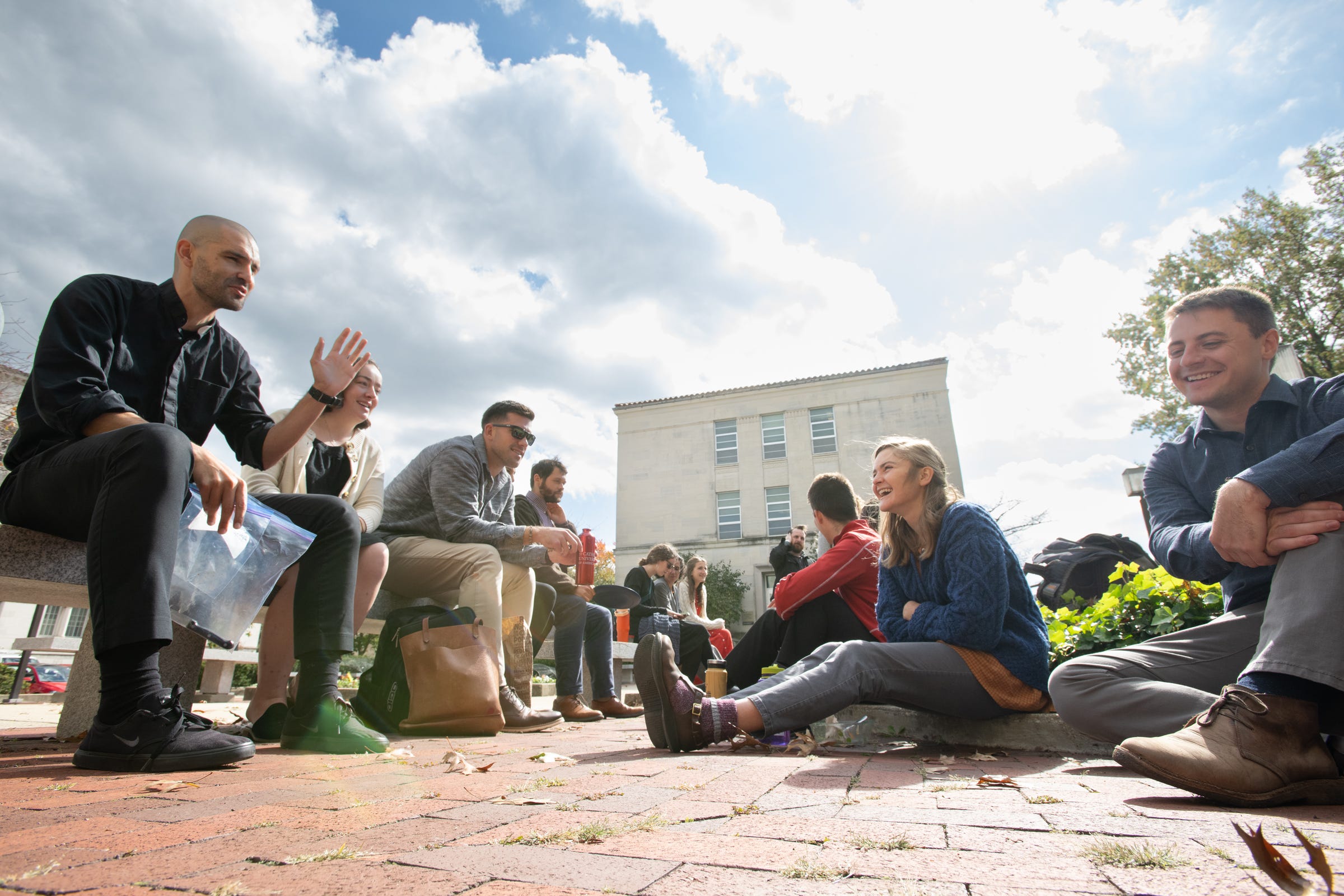 Students share a moment of laughter and camaraderie on the campus of CUA between classes. 