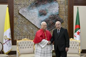 Pope Leo XIV shakes hands with Algerian President Abdelmadjid Tebboune at the Presidential Palace in Algiers, Monday, April 13, 2026. 
