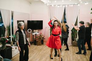 Couples dance as instructor Sharon Boies looks on.