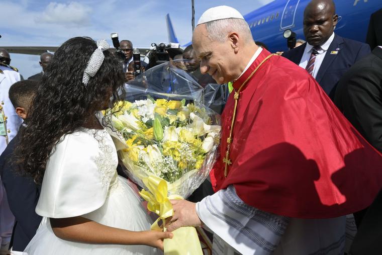 Pope Leo XIV is greeted by a young Catholic upon his arrival at Yaoundé-Nsimalen International Airport near Yaoundé, Cameroon, Wednesday, April 15, 2026.