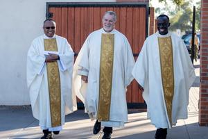 Father Greg Schlarb (center) will take on the new role of vicar for priestly life and ministry this summer.