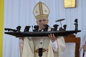 Pope Leo XIV holds a sculpture at Japoma Stadium in Douala, Cameroon, on Friday, April 17, 2026.