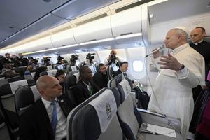 Pope Leo XIV speaks to journalists aboard the papal plane en route to Quatro de Fevereiro Airport in Luanda, Angola, Saturday, April 18, 2026. 