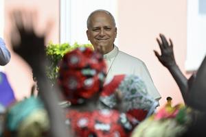 Pope Leo smiles to the crowd during April 20, 2026, visit to a home for the elderly in Angola.