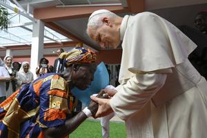 Pope Leo XIV greets an elderly woman during his visit to a nursing home in Saurimo, Angola, on April 20, 2026.