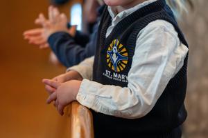 A student prays during Mass at St. Mary Catholic Virtue Preschool in Littleton, Colorado. 