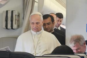 Pope Leo XIV speaks to reporters on the papal flight to Equatorial Guinea on April 21, 2026.