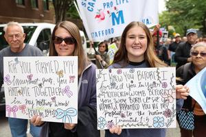 Two women hold pro-life signs at their state March for Life in Richmond, Virginia, on April 22, 2026. 