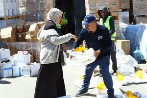 Catholic Relief Services workers help to distribute humanitarian aid materials to Gazan civilians in March 2024. 