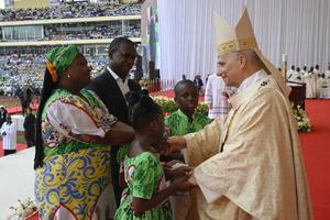 Pope Leo greets a family during Mass at Malabo Stadium in Equatorial Guinea on April 23, 2026.