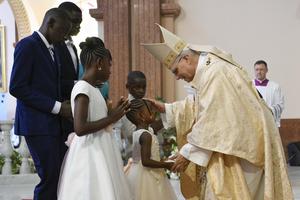 Pope Leo blesses a family at Holy Mass at the Basilica of the Immaculate Conception in Mongomo, Equatorial Guinea, on April 22, 2026.