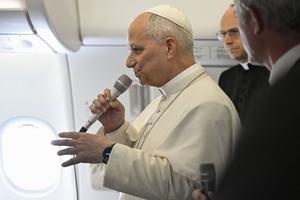 Pope Leo speaks on the papal plane from Equatorial Guinea to Italy after his Africa trip on April 23, 2026.