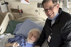 Father Larry Holland is shown at Vancouver General Hospital with chaplain Father Ronald Sequeira. While recovering from a hip fracture Holland was twice offered euthanasia.