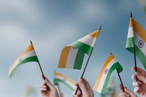 People hold the Indian national flag. The results of staggered assembly elections in four Indian states were declared on May 4, 2026.