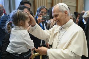 Pope Leo blesses a child on May 2.