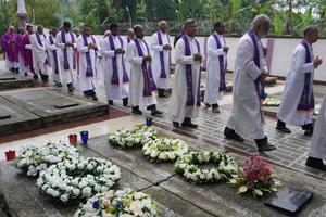 Salesian priests pray at the graves of three members of their order killed in 2001 during a 25th-anniversary memorial Mass at the provincial cemetery in Dimapur, India, on May 15, 2026.