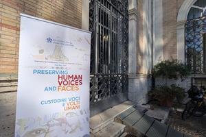A banner for the conference “Preserving Human Voices and Faces” at the Pontifical Urban University on May 21, 2026, in Rome. 
