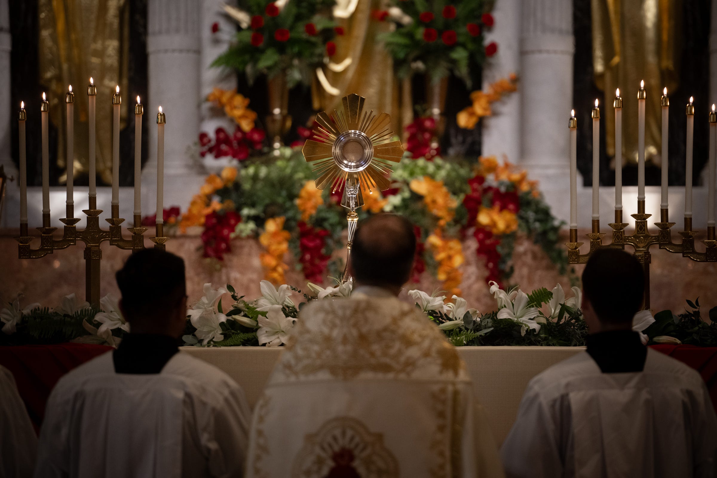 By evening, the pilgrimage reached the Cathedral Basilica of St. Augustine, where the Eucharist was enthroned amid candlelight and flowers for adoration through the night.